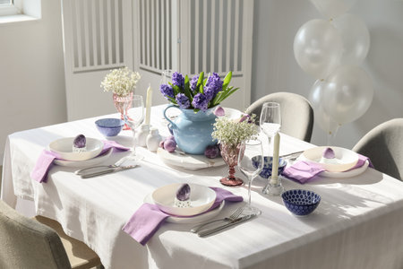 Stylish table setting for Easter celebration in the room