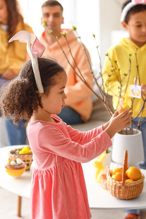 Little African-American girl with Easter eggs at homeの写真素材