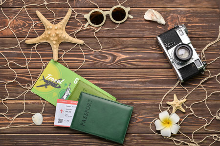 Frame made of passports, starfishes, photo camera and sunglasses on dark wooden backgroundの写真素材