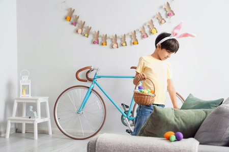 Cute little boy looking for hidden Easter eggs at home