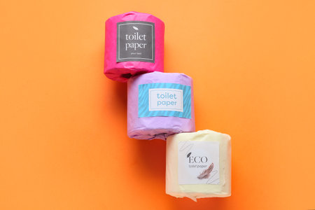 Toilet paper rolls on orange background