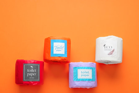Toilet paper rolls on orange background