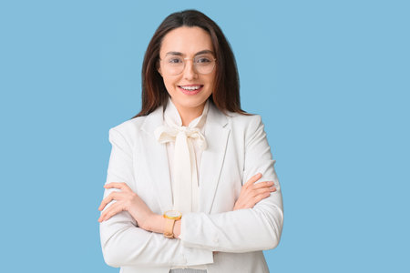 portrait of young secretary on blue backgroundの写真素材