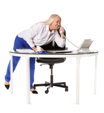 Mature secretary talking by phone on white backgroundの写真素材