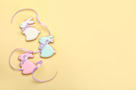 Delicious Easter cookies in shape of bunny on beige backgroundの写真素材