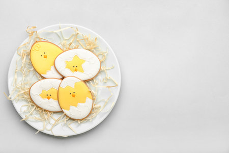 Plate with tasty Easter cookies on gray backgroundの写真素材