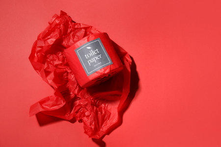 Toilet paper roll on red backgroundの写真素材