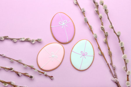 Composition with creative Easter cookies and pussy willow branches on purple backgroundの写真素材