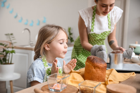 Little girl with baked Easter cake in the kitchen
