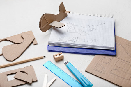 Materials for making cardboard plane toy on white backgroundの写真素材