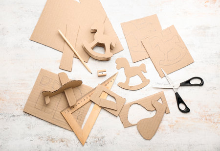 Materials for making cardboard toys on light background