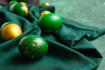 Stylish Easter eggs on green backgroundの写真素材