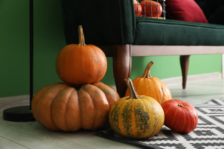 Fresh pumpkins on floor in living room, closeupの写真素材
