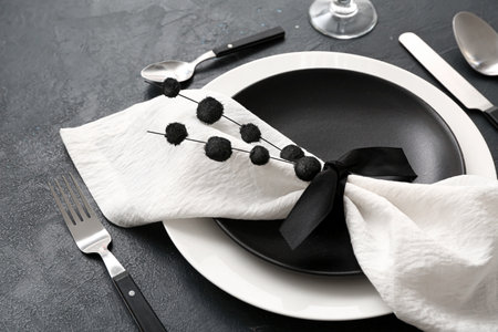 Stylish elegant table setting on dark background, closeup