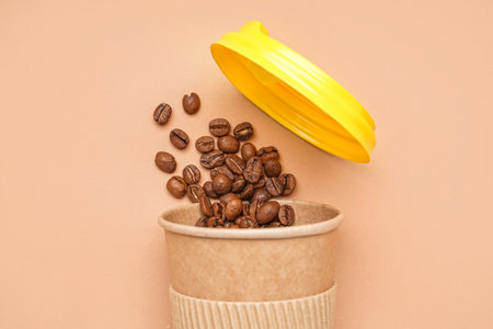 Paper cup with coffee beans on color background, closeupの写真素材
