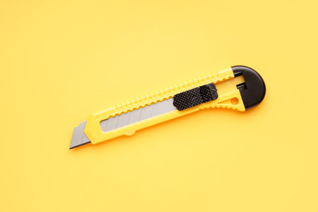 utility knife on yellow background