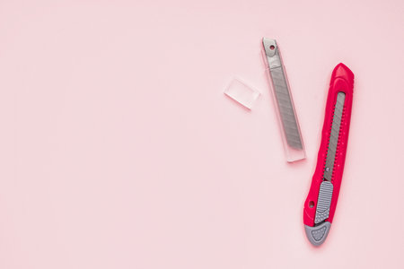 Utility knife with blades on pink backgroundの写真素材