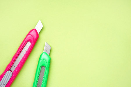 Utility knives on green background
