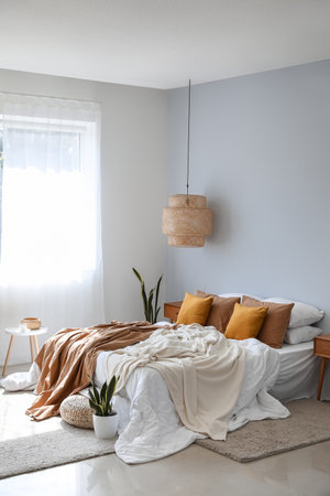Interior of modern room with big bed, houseplants and lamp