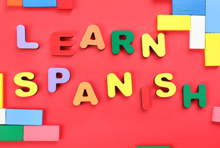 Text LEARN SPANISH with colorful blocks on red backgroundの写真素材