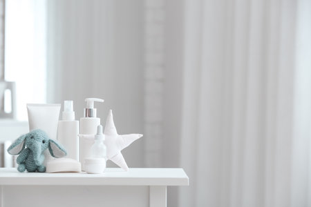 Bath supplies for children and toys on white table in light bathroom