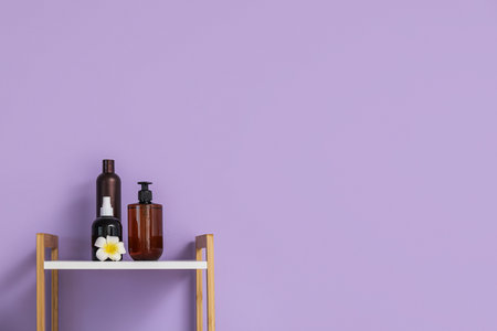 Bath accessories on shelf near color wallの写真素材