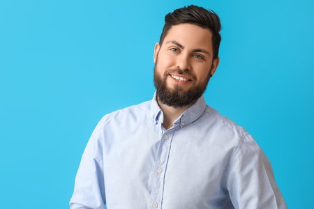Stylish bearded man on blue backgroundの写真素材