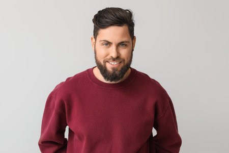 Stylish bearded man on light backgroundの写真素材