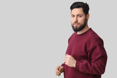 Stylish bearded man on light backgroundの写真素材