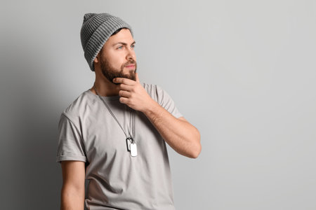 Stylish cool bearded man on gray backgroundの写真素材