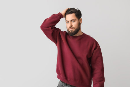 Stylish bearded man on light backgroundの写真素材