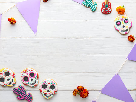 Frame made of cookies, flowers and flags on white wooden background. El Dia de Muertosの写真素材