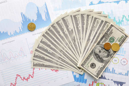 Dollar banknotes with cents on diagrams. Exchange rate concept
