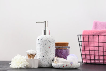 Set of bath supplies on table near light wall