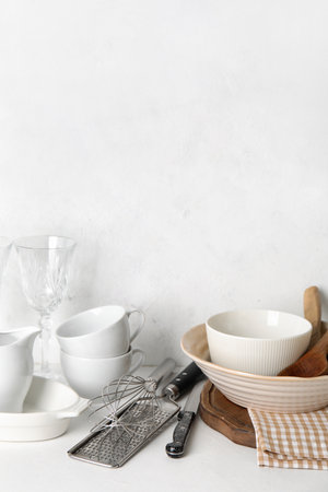 Set of different dishware and kitchenware on white tableの写真素材