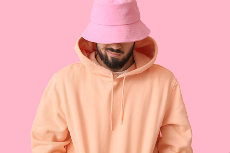 Fashionable bearded man on pink background