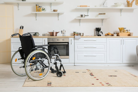 Modern empty wheelchair in kitchenの写真素材