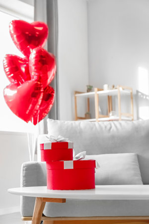 Gift boxes on table in room decorated for Valentine's dayの写真素材