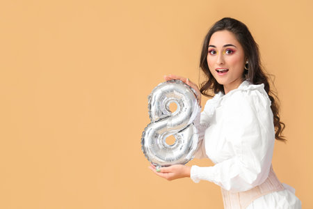 Emotional woman holding balloon in shape of figure 8 on color background. International Women's Day