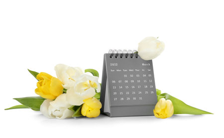 Calendar and flowers for International Women's Day celebration on white backgroundの写真素材