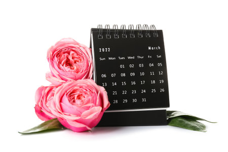 Calendar and flowers for International Women's Day celebration on white backgroundの写真素材