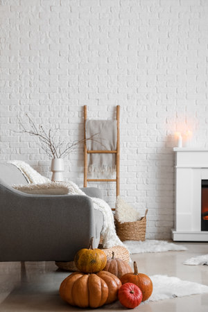 Interior of cozy living room with pumpkins, sofa and fireplaceの写真素材
