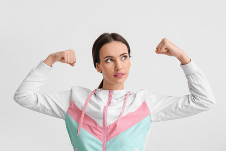 Strong young woman on light background. immunity conceptの写真素材