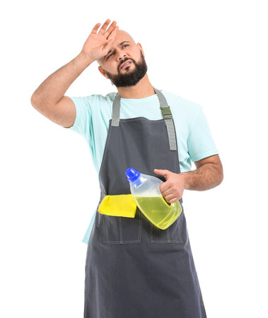 Tired bald man with cleaning supplies isolated on whiteの写真素材