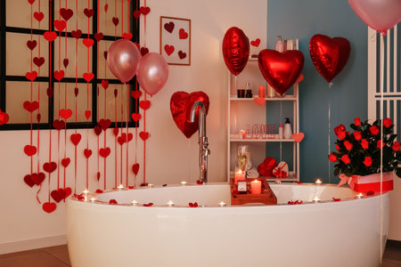 Interior of beautiful bathroom with burning candles decorated for Valentine's Day in the eveningの写真素材