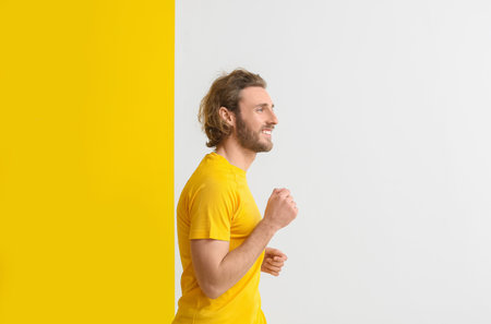 Sporty running man on color backgroundの写真素材