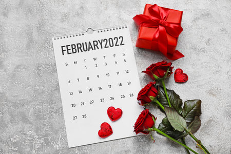 Calendar with roses, hearts and gift on grunge background. Valentine's Day celebration