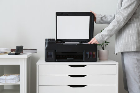 Businesswoman copying document in light office