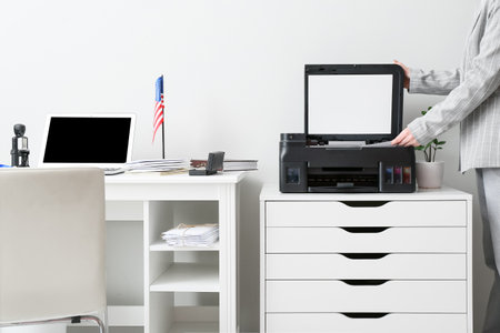 Businesswoman copying document in light office