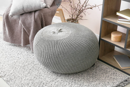 Modern pouf in interior of room, closeup